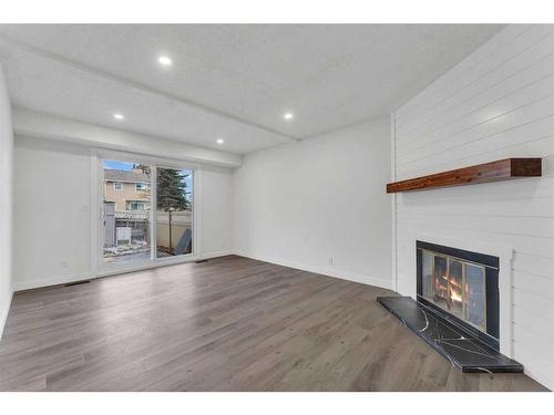 22-5520 1 Avenue Se, Calgary, AB - Indoor Photo Showing Living Room With Fireplace