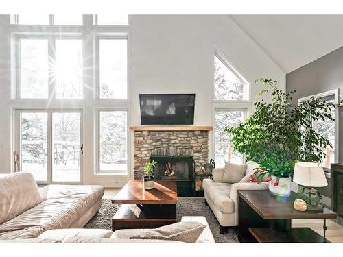 10 Ghost Country Place, Waiparous, AB - Indoor Photo Showing Living Room With Fireplace