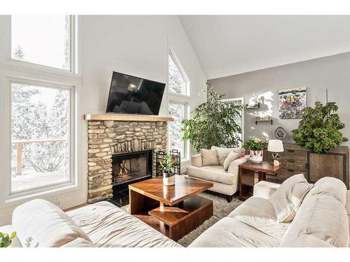 10 Ghost Country Place, Waiparous, AB - Indoor Photo Showing Living Room With Fireplace