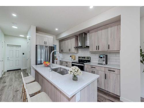 106-116 Saddlestone Heath Ne, Calgary, AB - Indoor Photo Showing Kitchen With Stainless Steel Kitchen With Double Sink With Upgraded Kitchen