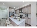 106-116 Saddlestone Heath Ne, Calgary, AB  - Indoor Photo Showing Kitchen With Stainless Steel Kitchen With Double Sink With Upgraded Kitchen 