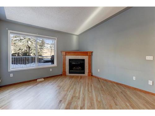 24 Signature Villas Sw, Calgary, AB - Indoor Photo Showing Living Room With Fireplace