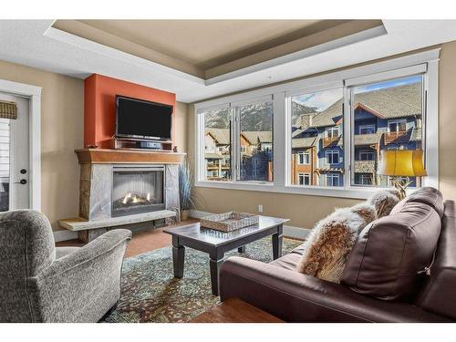 301-173 Kananaskis Way, Canmore, AB - Indoor Photo Showing Living Room With Fireplace