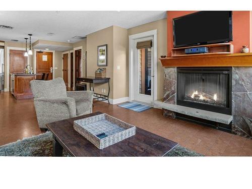 301-173 Kananaskis Way, Canmore, AB - Indoor Photo Showing Living Room With Fireplace