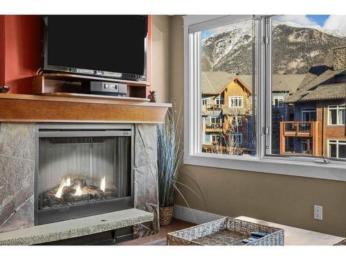 301-173 Kananaskis Way, Canmore, AB - Indoor Photo Showing Living Room With Fireplace