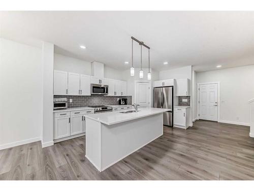 63 Belgian Crescent, Cochrane, AB - Indoor Photo Showing Kitchen With Upgraded Kitchen