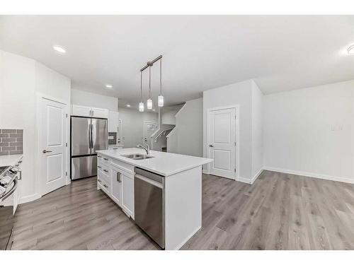 63 Belgian Crescent, Cochrane, AB - Indoor Photo Showing Kitchen With Double Sink