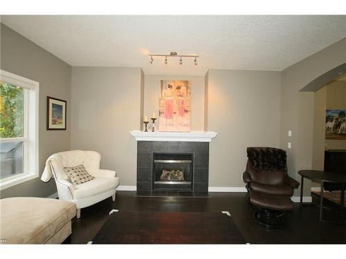 254 Cougarstone Gardens Sw, Calgary, AB - Indoor Photo Showing Living Room With Fireplace