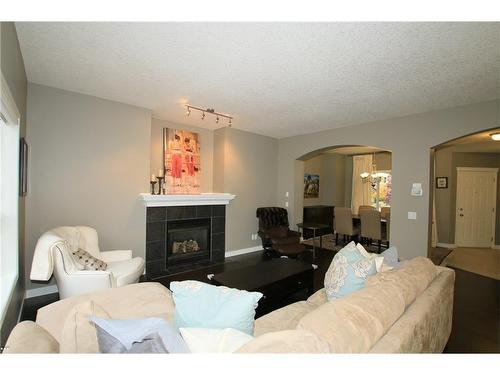 254 Cougarstone Gardens Sw, Calgary, AB - Indoor Photo Showing Living Room With Fireplace