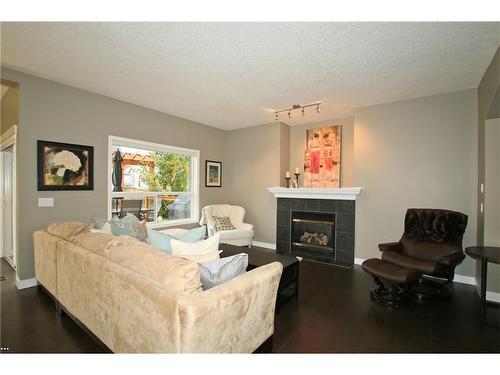 254 Cougarstone Gardens Sw, Calgary, AB - Indoor Photo Showing Living Room With Fireplace