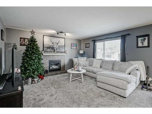 2196 Luxstone Boulevard Sw, Airdrie, AB - Indoor Photo Showing Living Room With Fireplace