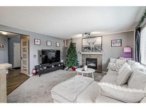 2196 Luxstone Boulevard Sw, Airdrie, AB - Indoor Photo Showing Living Room With Fireplace