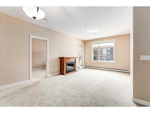 311-35 Aspenmont Heights Sw, Calgary, AB - Indoor With Fireplace