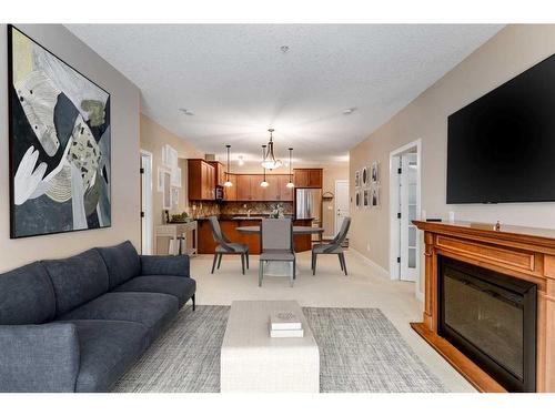 311-35 Aspenmont Heights Sw, Calgary, AB - Indoor Photo Showing Living Room With Fireplace