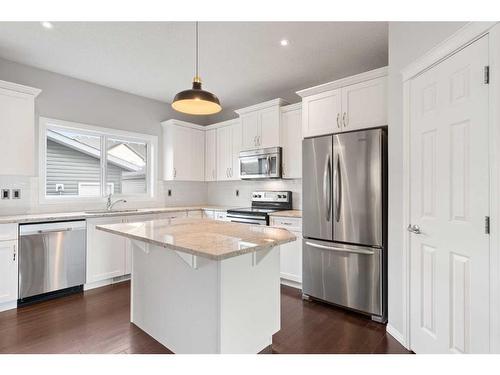 108 Heartland Way, Cochrane, AB - Indoor Photo Showing Kitchen With Upgraded Kitchen