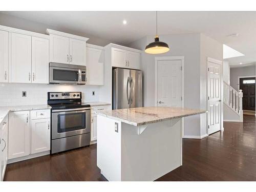 108 Heartland Way, Cochrane, AB - Indoor Photo Showing Kitchen With Upgraded Kitchen