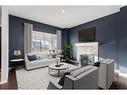 108 Heartland Way, Cochrane, AB  - Indoor Photo Showing Living Room With Fireplace 