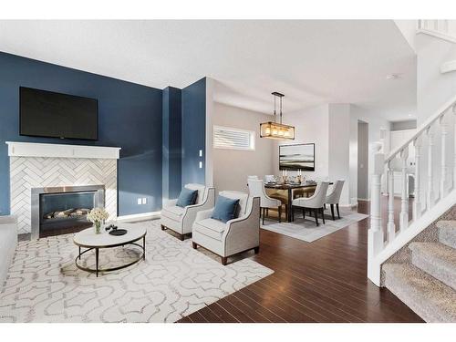 108 Heartland Way, Cochrane, AB - Indoor Photo Showing Living Room With Fireplace