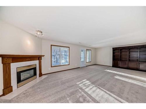 13 Arbour Cliff Close Nw, Calgary, AB - Indoor Photo Showing Living Room With Fireplace