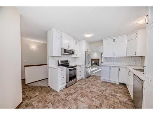 13 Arbour Cliff Close Nw, Calgary, AB - Indoor Photo Showing Kitchen With Stainless Steel Kitchen