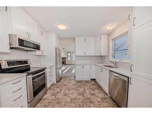 13 Arbour Cliff Close Nw, Calgary, AB - Indoor Photo Showing Kitchen With Stainless Steel Kitchen With Double Sink With Upgraded Kitchen