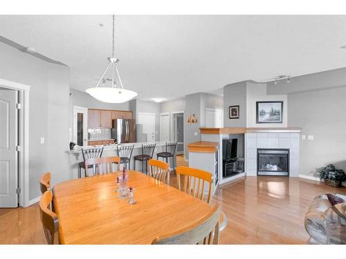 110-60 Sierra Morena Landing Sw, Calgary, AB - Indoor Photo Showing Dining Room With Fireplace