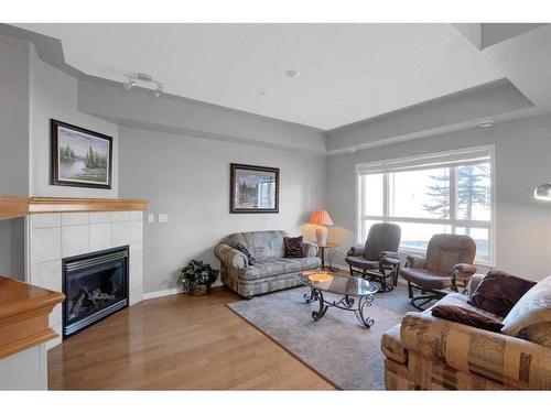 110-60 Sierra Morena Landing Sw, Calgary, AB - Indoor Photo Showing Living Room With Fireplace