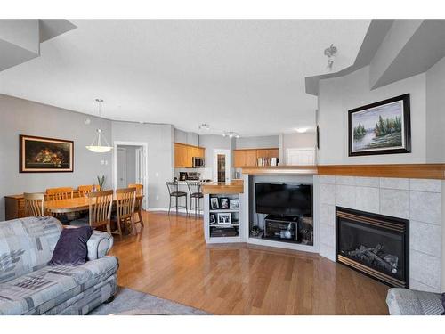 110-60 Sierra Morena Landing Sw, Calgary, AB - Indoor Photo Showing Living Room With Fireplace