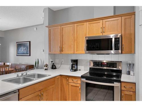 110-60 Sierra Morena Landing Sw, Calgary, AB - Indoor Photo Showing Kitchen With Double Sink