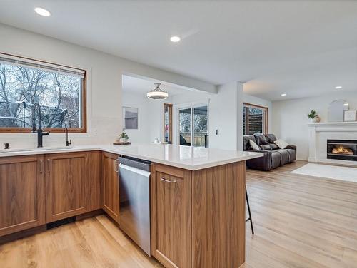 10 Crystalridge Way, Okotoks, AB - Indoor Photo Showing Kitchen With Fireplace