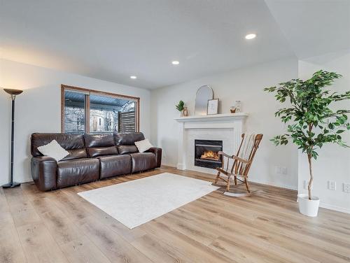 10 Crystalridge Way, Okotoks, AB - Indoor Photo Showing Living Room With Fireplace