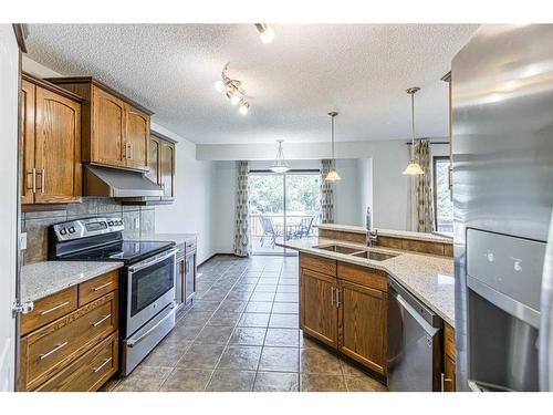 48 Eversyde Manor Sw, Calgary, AB - Indoor Photo Showing Kitchen With Double Sink