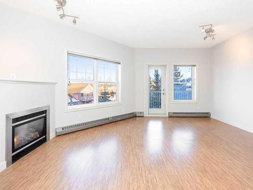 302-1408 17 Street Se, Calgary, AB - Indoor Photo Showing Other Room With Fireplace