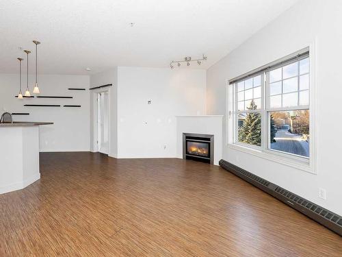 302-1408 17 Street Se, Calgary, AB - Indoor Photo Showing Living Room With Fireplace