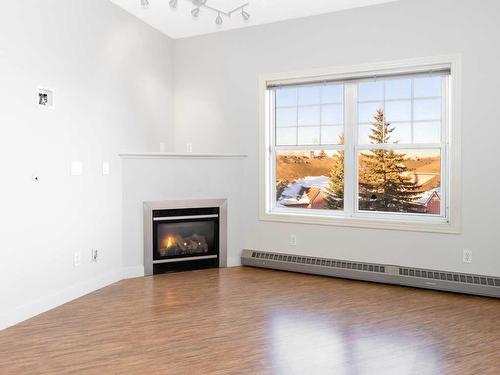 302-1408 17 Street Se, Calgary, AB - Indoor Photo Showing Living Room With Fireplace