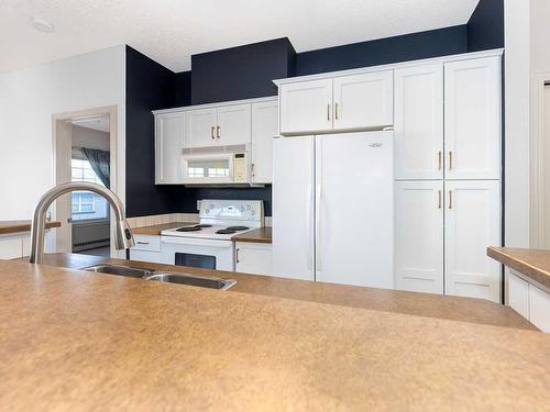 302-1408 17 Street Se, Calgary, AB - Indoor Photo Showing Kitchen With Double Sink