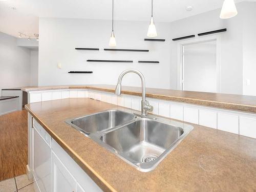 302-1408 17 Street Se, Calgary, AB - Indoor Photo Showing Kitchen With Double Sink