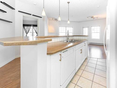 302-1408 17 Street Se, Calgary, AB - Indoor Photo Showing Kitchen With Double Sink