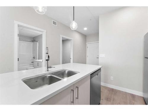 405-660 Shawnee Square Sw, Calgary, AB - Indoor Photo Showing Kitchen With Double Sink