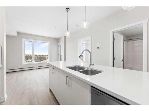 405-660 Shawnee Square Sw, Calgary, AB - Indoor Photo Showing Kitchen With Double Sink With Upgraded Kitchen