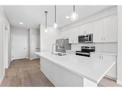 405-660 Shawnee Square Sw, Calgary, AB - Indoor Photo Showing Kitchen With Double Sink With Upgraded Kitchen