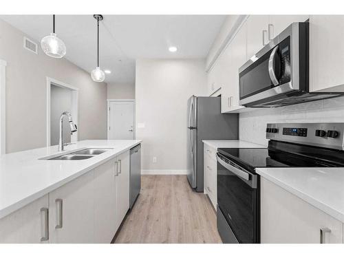 405-660 Shawnee Square Sw, Calgary, AB - Indoor Photo Showing Kitchen With Double Sink