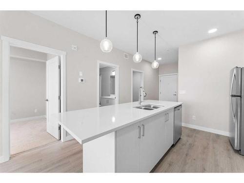 405-660 Shawnee Square Sw, Calgary, AB - Indoor Photo Showing Kitchen With Double Sink