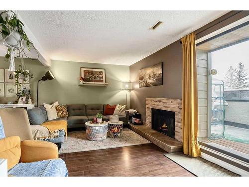 703-2520 Palliser Drive Sw, Calgary, AB - Indoor Photo Showing Living Room With Fireplace