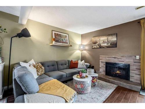 703-2520 Palliser Drive Sw, Calgary, AB - Indoor Photo Showing Living Room With Fireplace