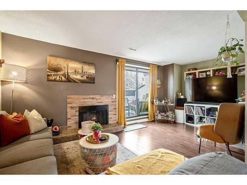 703-2520 Palliser Drive Sw, Calgary, AB - Indoor Photo Showing Living Room With Fireplace