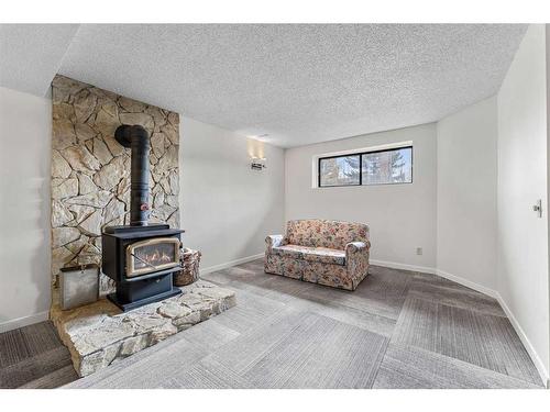 12 Glenport Road, Cochrane, AB - Indoor Photo Showing Living Room With Fireplace