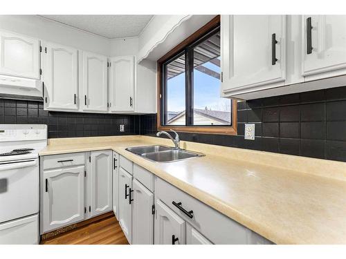 12 Glenport Road, Cochrane, AB - Indoor Photo Showing Kitchen With Double Sink