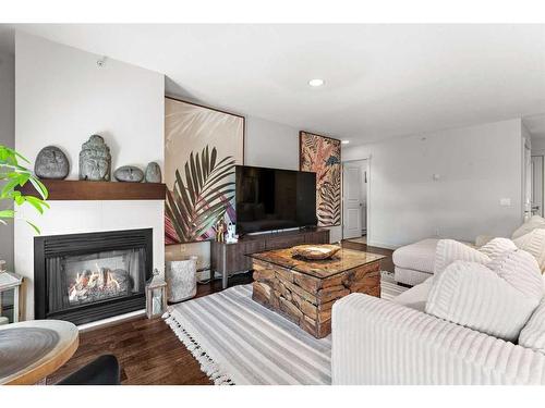 302-4704 Stanley Road Sw, Calgary, AB - Indoor Photo Showing Living Room With Fireplace