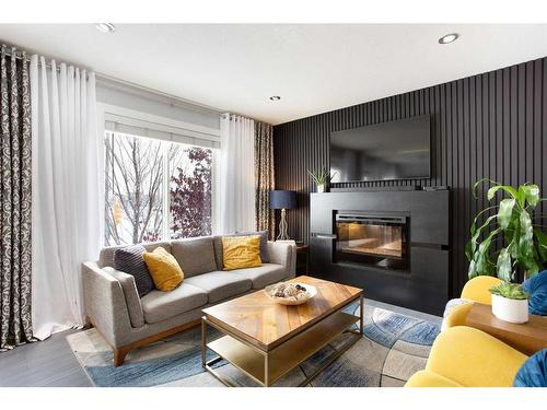 106-800 Yankee Valley Boulevard Se, Airdrie, AB - Indoor Photo Showing Living Room With Fireplace